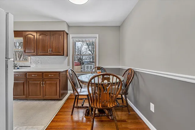 a dining room with furniture and window