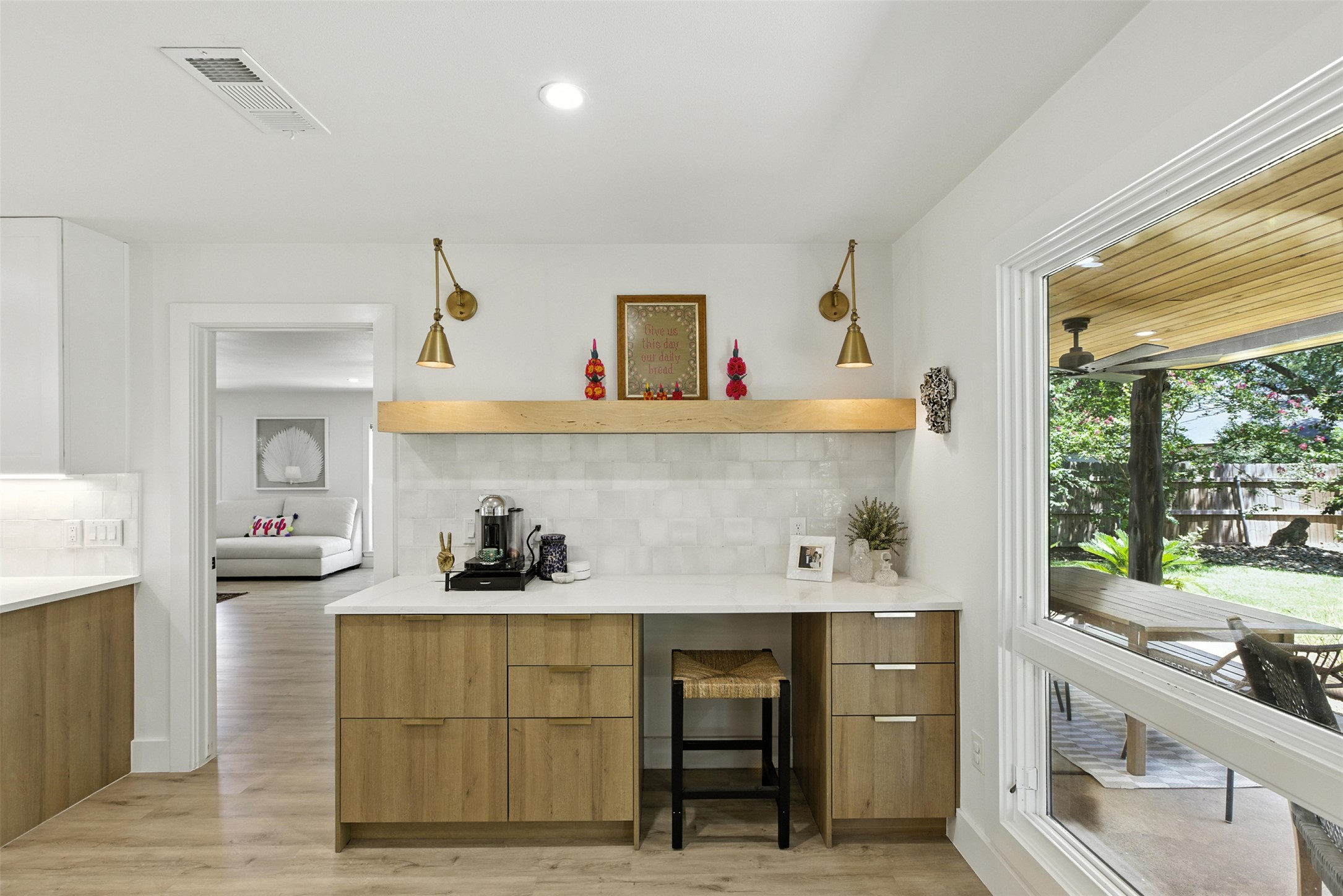 2403 Gateshead Circle Austin, TX 78745 - Photo 10 of 22 A well-appointed built-in desk with cabinetry with crisp white subway tile backsplash opens to an inviting outdoor living area.