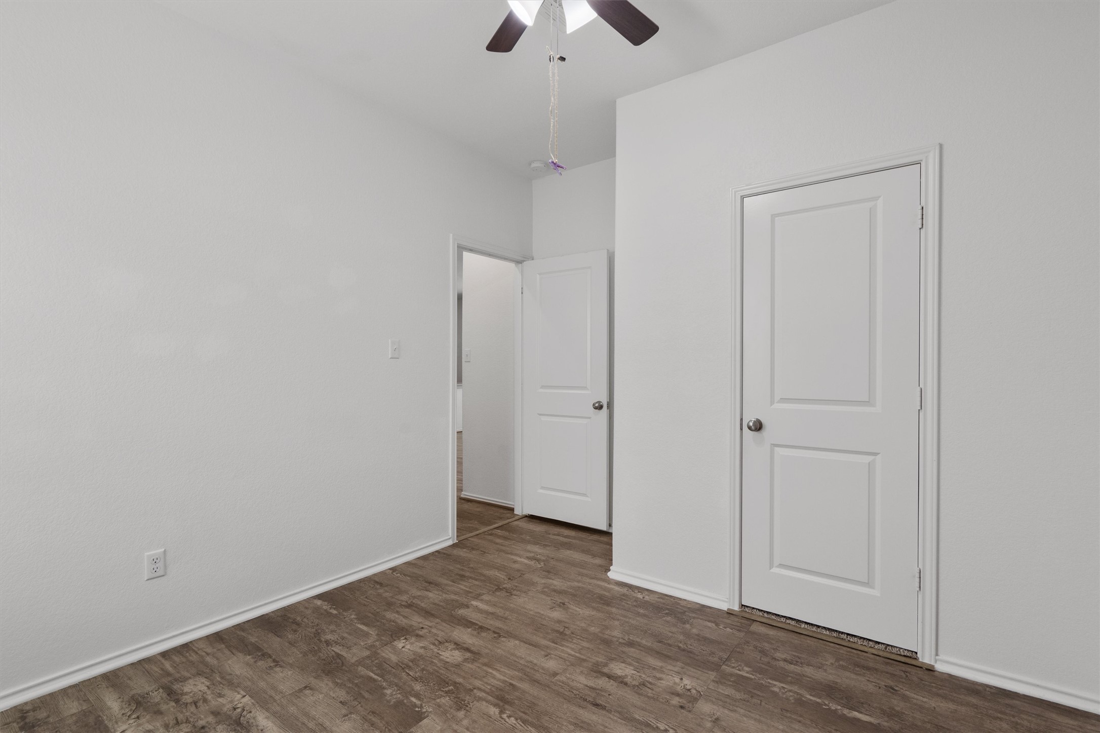 791 Circle Way Jarrell, TX 76537 - Photo 23 of 36 Room featuring wood-finish flooring, white baseboards, and neutral wall paint