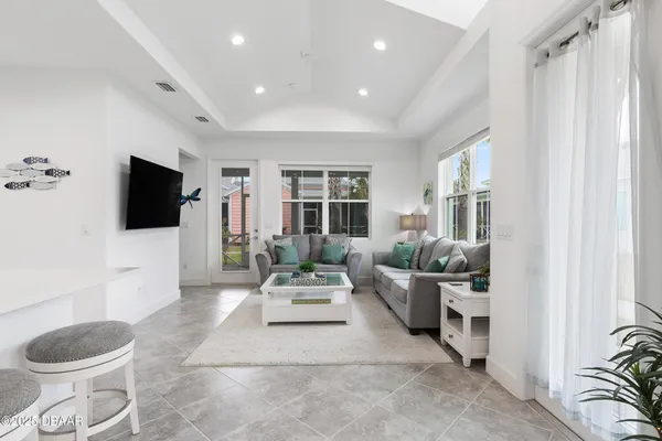 a living room with furniture and a chandelier