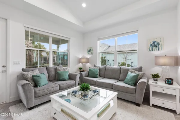 a dining room with furniture a window and a chandelier