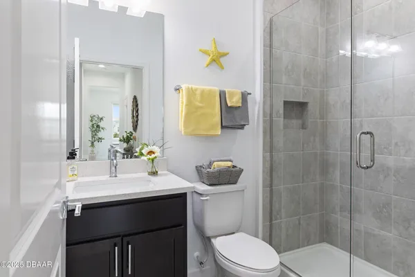 an aerial view of residential houses with outdoor space and parking