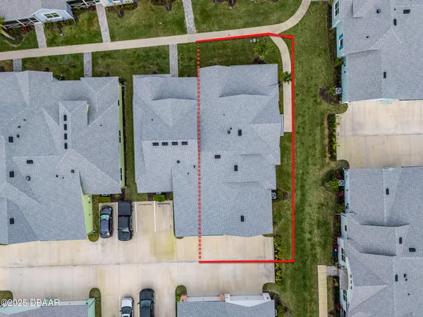 an aerial view of residential houses with outdoor space