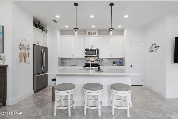 a kitchen with stainless steel appliances a stove microwave and cabinets