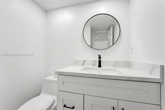 a bathroom with a sink a mirror and a toilet