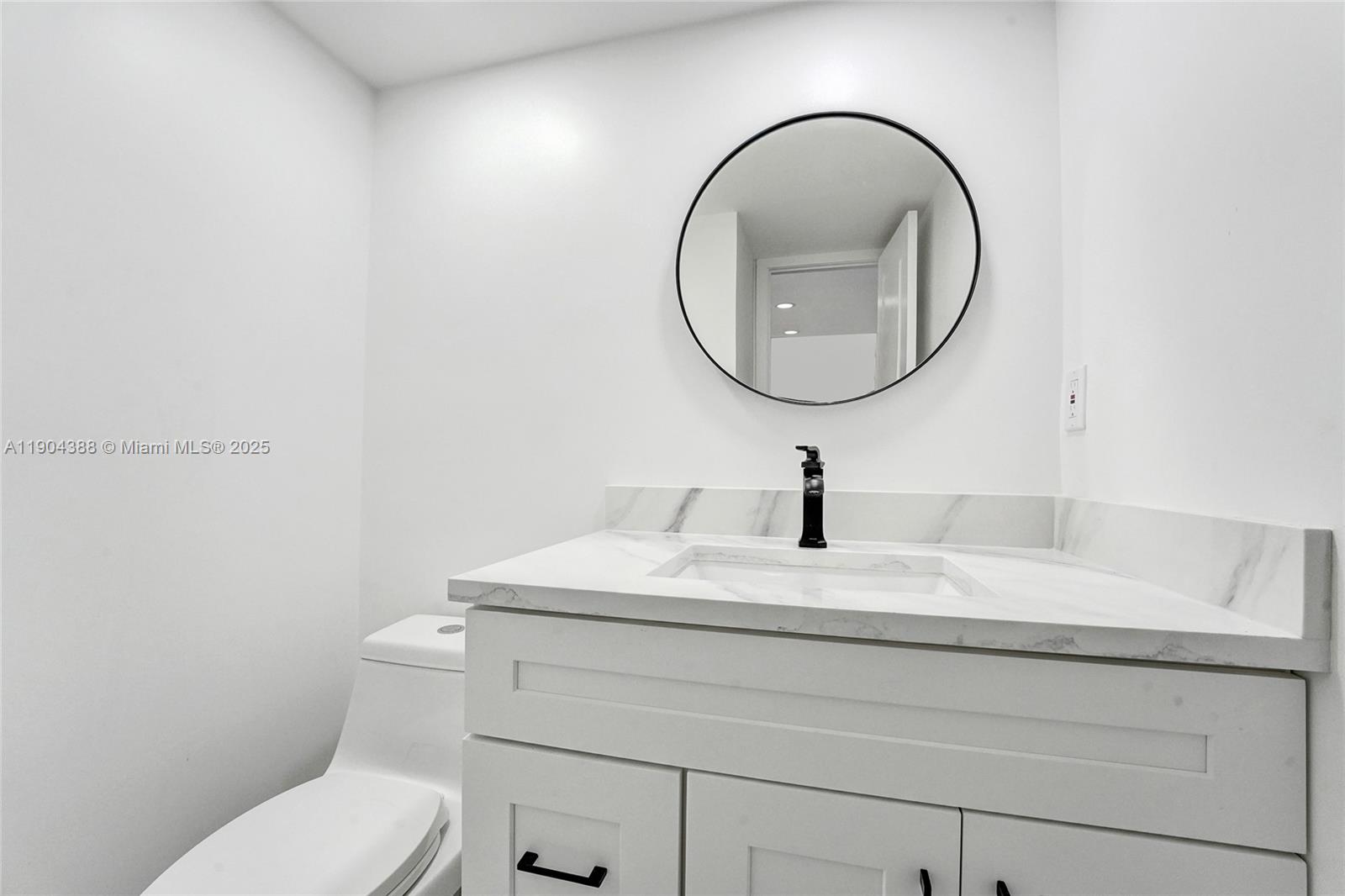 8900 Washington Street, Unit 506A Pembroke Pines, FL 33025 - Photo 13 of 28 a bathroom with a sink a mirror and a toilet