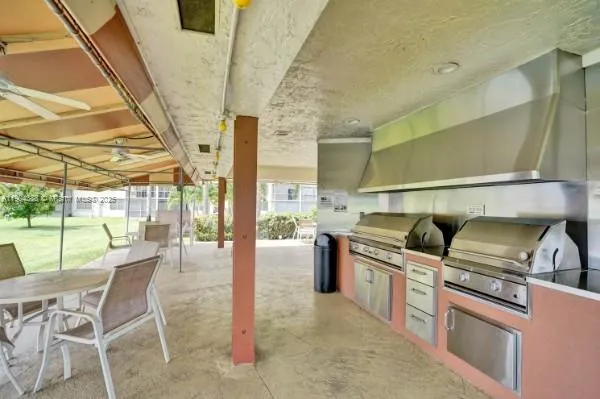 a kitchen with stainless steel appliances granite countertop a stove and a refrigerator