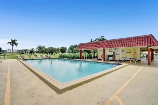 a view of swimming pool with a bench in patio