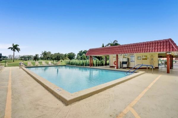 8900 Washington Street, Unit 506A Pembroke Pines, FL 33025 - Photo 24 of 28 a view of swimming pool with a bench in patio