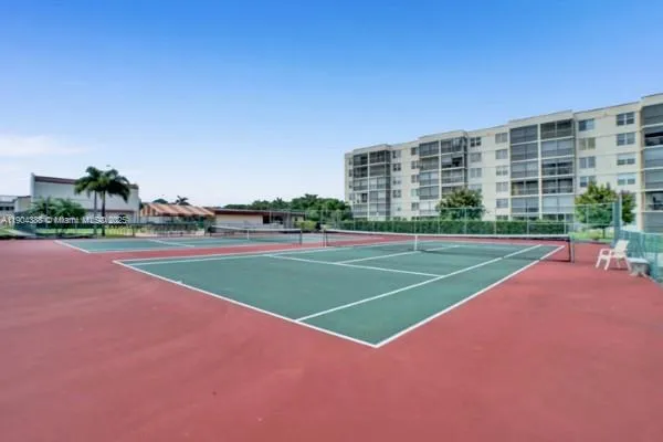 a view of a big room with a big yard and large trees