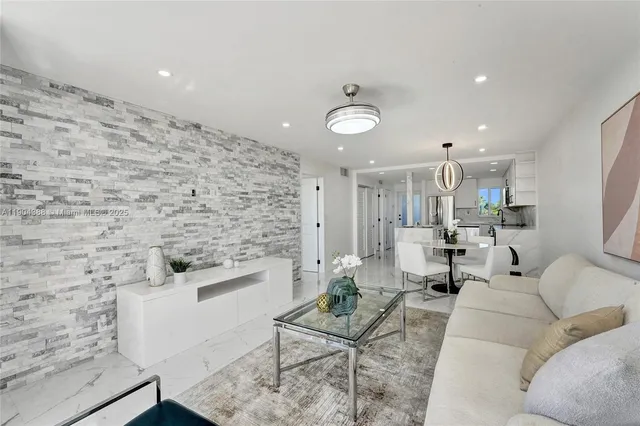 a living room with furniture wooden floor and a chandelier