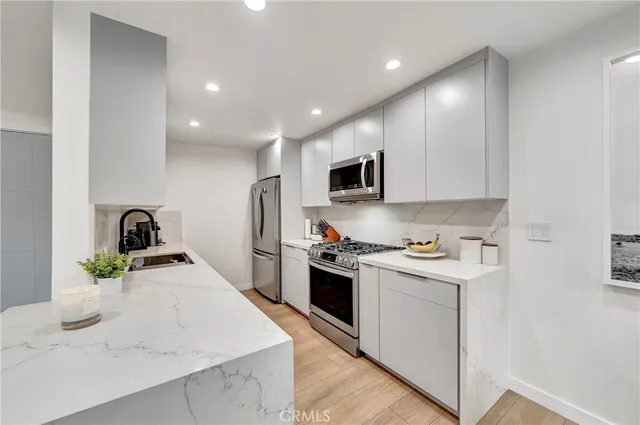a kitchen with a sink a stove and cabinets