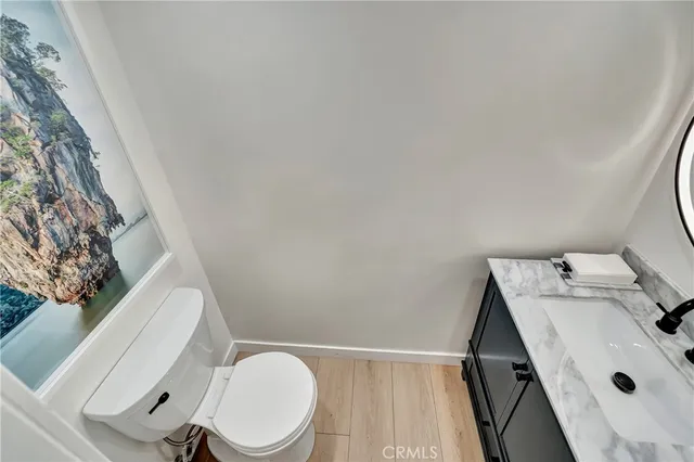 a white toilet sitting next to a sink