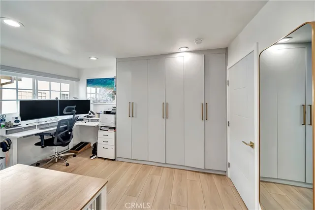 a view of a workspace with furniture and a window