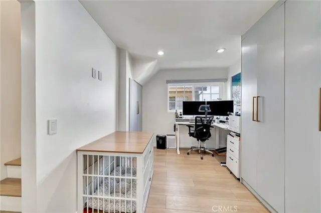 a living room with stainless steel appliances kitchen island granite countertop a refrigerator and a sink