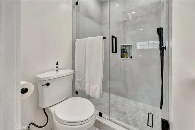 a bathroom with a toilet a sink and shower