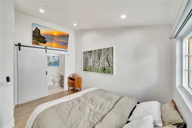 a bedroom with a bed and a large window