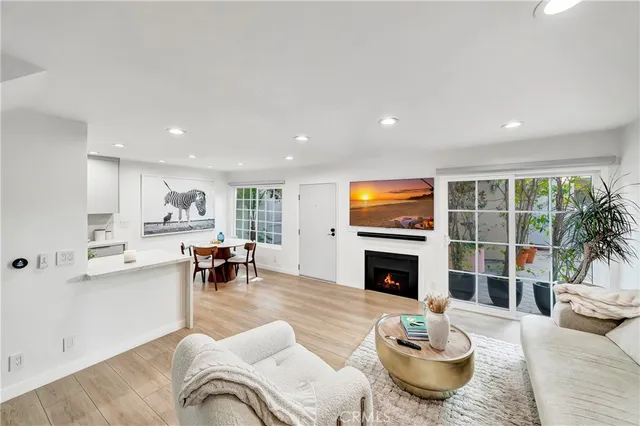 a living room with furniture kitchen and a fireplace