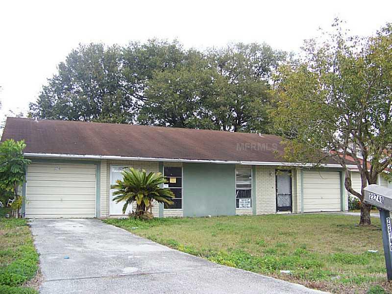 22740 Penny Loop Land O' Lakes, FL 34639 - Photo 1 of 1 a view of a yard in front of a house with large tree
