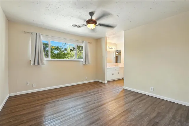 a bathroom with a granite countertop sink a mirror and a shower