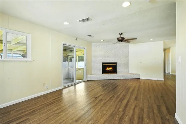 a kitchen with stainless steel appliances granite countertop a refrigerator a stove and a wooden floors