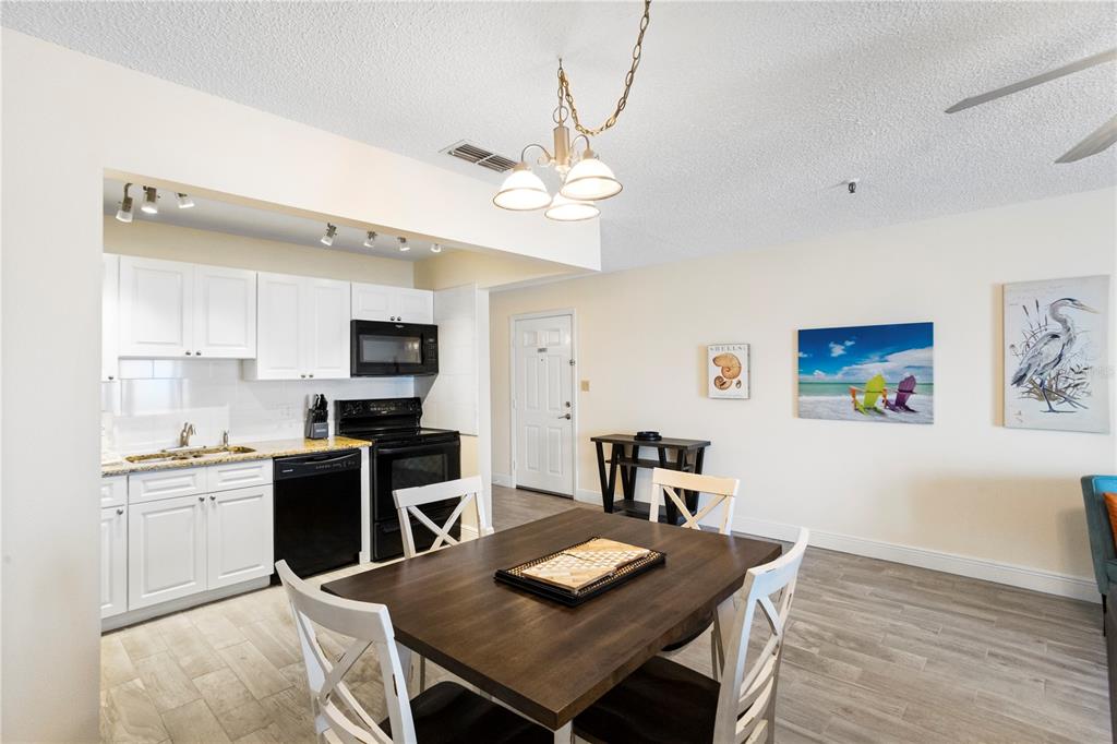13500 Gulf Boulevard, Unit 505 Madeira Beach, FL 33708 - Photo 12 of 42 a view of kitchen with cabinets and wooden floor