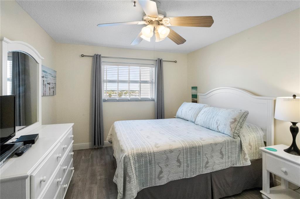 13500 Gulf Boulevard, Unit 505 Madeira Beach, FL 33708 - Photo 16 of 42 a bedroom with a bed and a flat screen tv