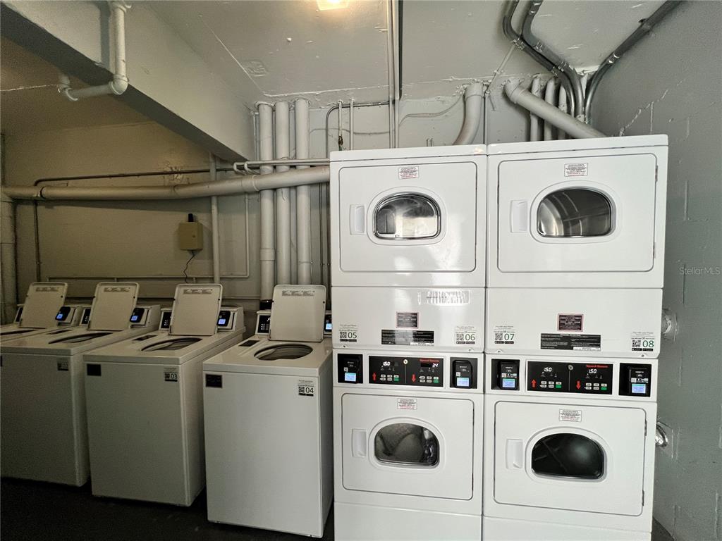13500 Gulf Boulevard, Unit 505 Madeira Beach, FL 33708 - Photo 22 of 42 a utility room with dryer washer and other items