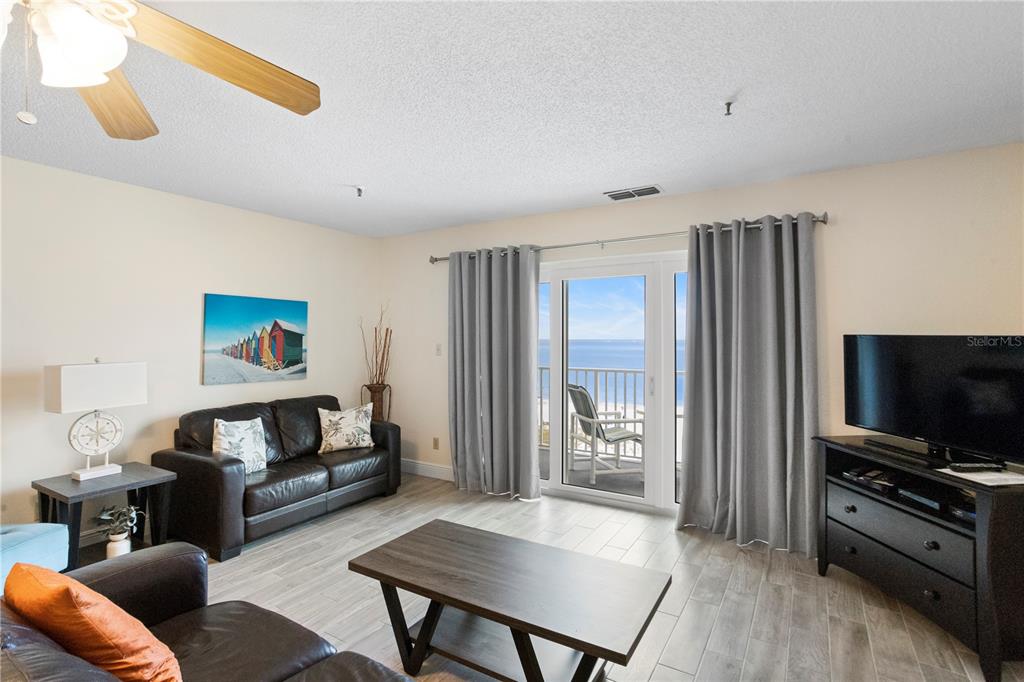 13500 Gulf Boulevard, Unit 505 Madeira Beach, FL 33708 - Photo 7 of 42 a living room with furniture and a flat screen tv