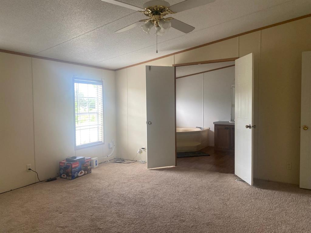 1928 East Foster Crossing Road Anna, TX 75409 - Photo 8 of 16 a view of a room with a ceiling fan and a window