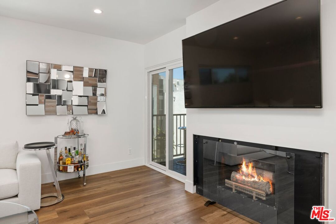 949 North Kings Road, Unit 302 West Hollywood, CA 90069 - Photo 4 of 16 a living room with furniture and a fireplace