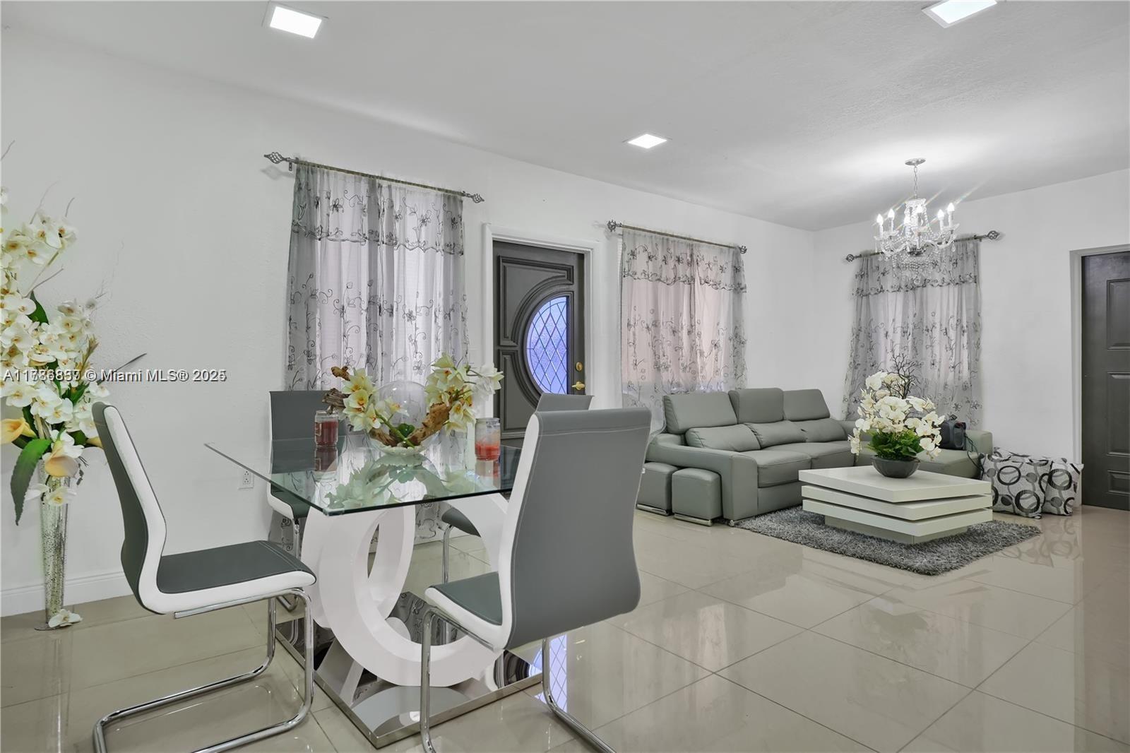 7225 Southwest 21st Street Miami, FL 33155 - Photo 1 of 16 a living room with furniture and a chandelier