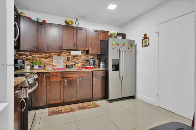 a kitchen with stainless steel appliances a refrigerator and cabinets