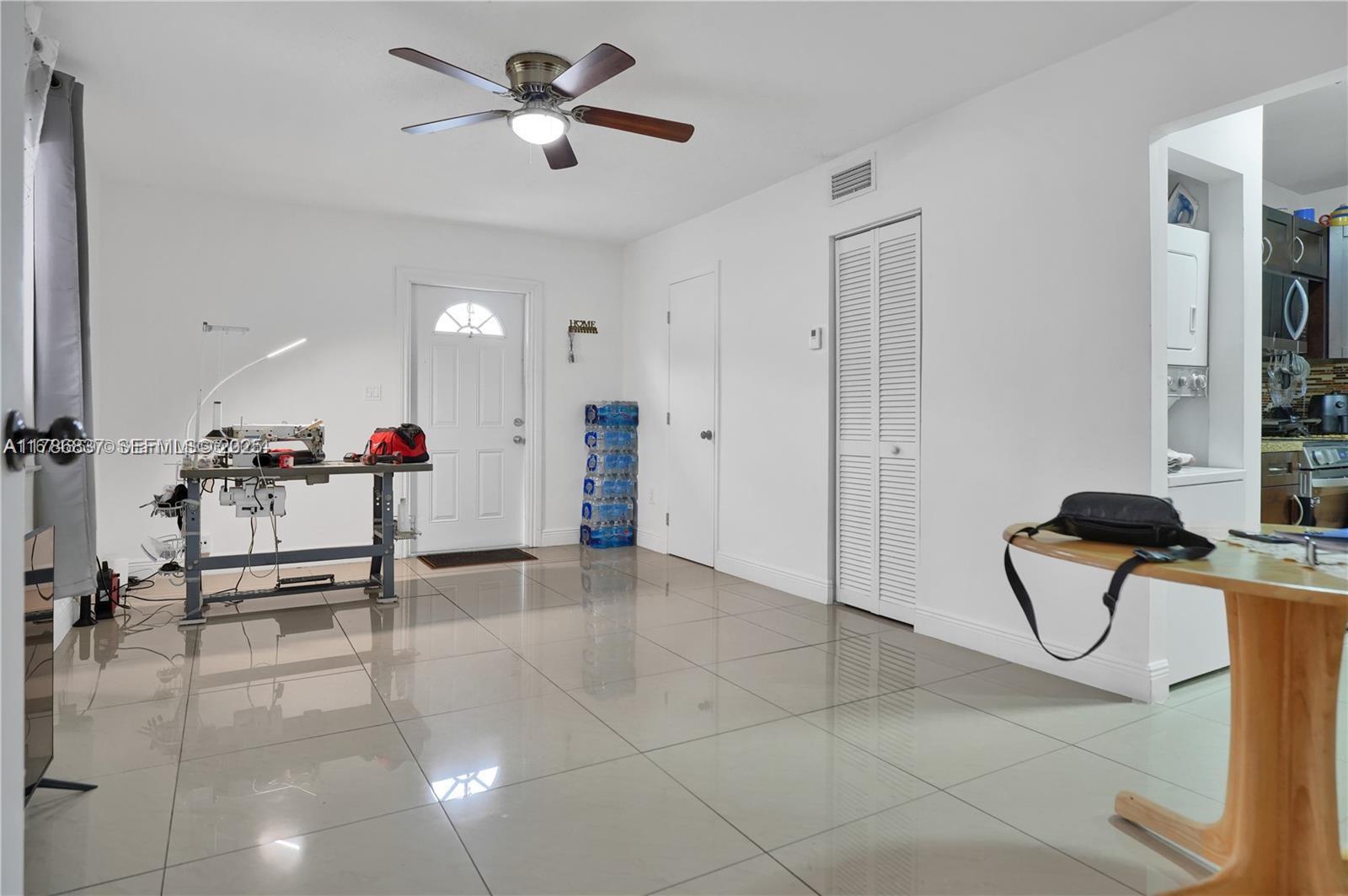 7225 Southwest 21st Street Miami, FL 33155 - Photo 13 of 16 a view of a livingroom with furniture and a gym equipment
