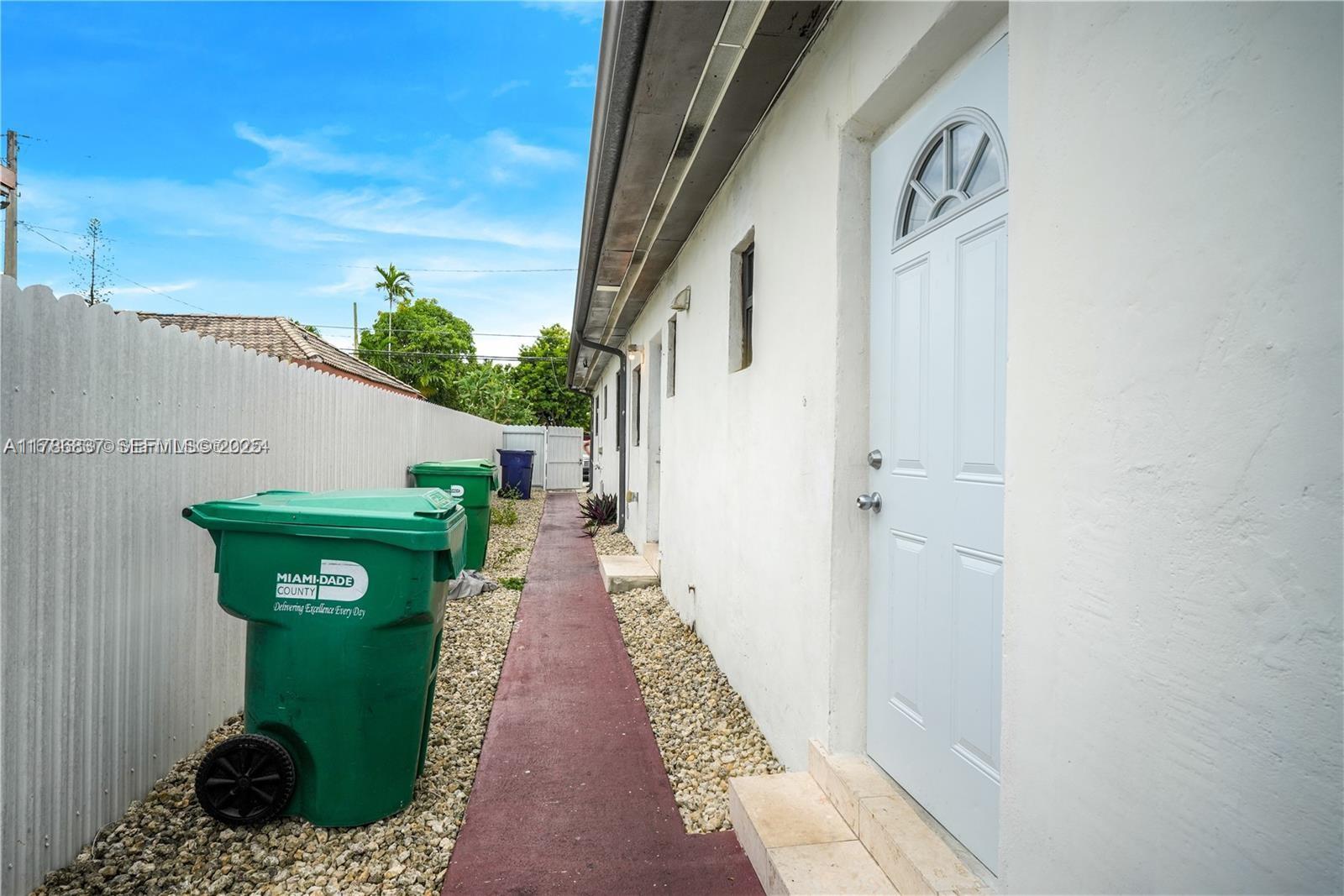 7225 Southwest 21st Street Miami, FL 33155 - Photo 14 of 16 a green house with garden in front of it