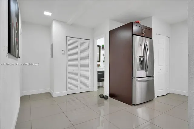 a kitchen with stainless steel appliances a refrigerator and a stove top oven