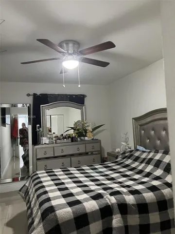 a bedroom with a bed and ceiling fan