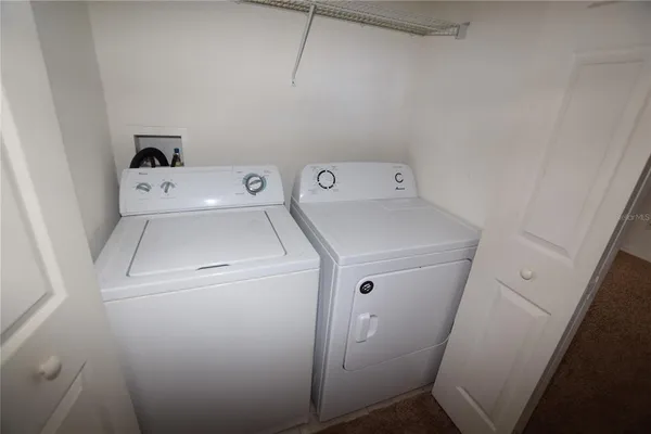 a view of backyard from deck having patio