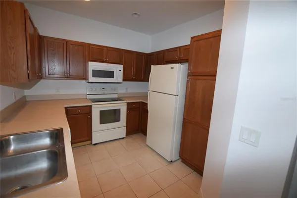 a kitchen with a refrigerator sink and microwave