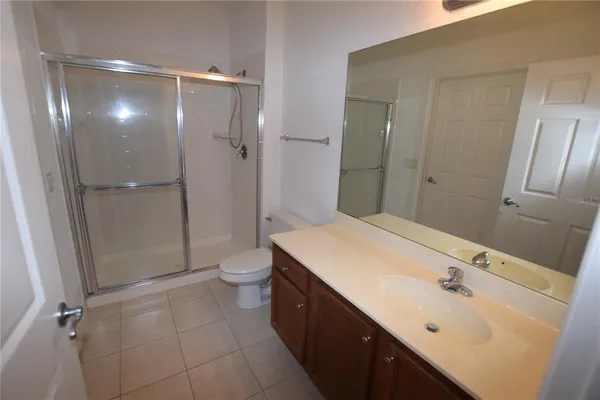 a bathroom with a double vanity sink toilet and shower
