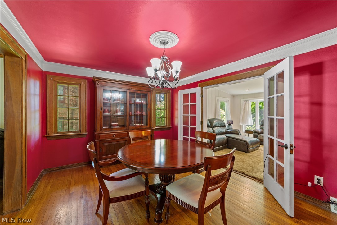 1237 Yellowstone Road Cleveland, OH 44121 - Photo 14 of 48 Dining room featuring hardwood / wood-style floors, a chandelier, and french doors