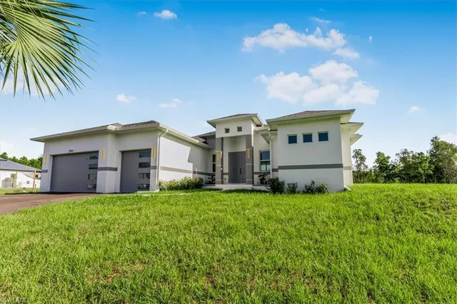 a front view of a house with a yard and garage