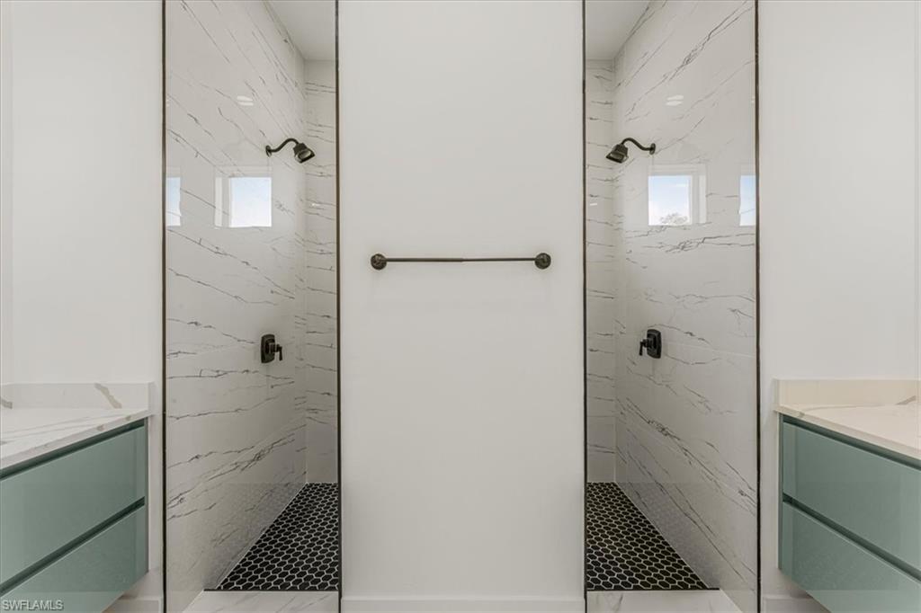 2941 37th Avenue Northeast Naples, FL 34120 - Photo 19 of 46 a bathroom with a bathtub and a shower