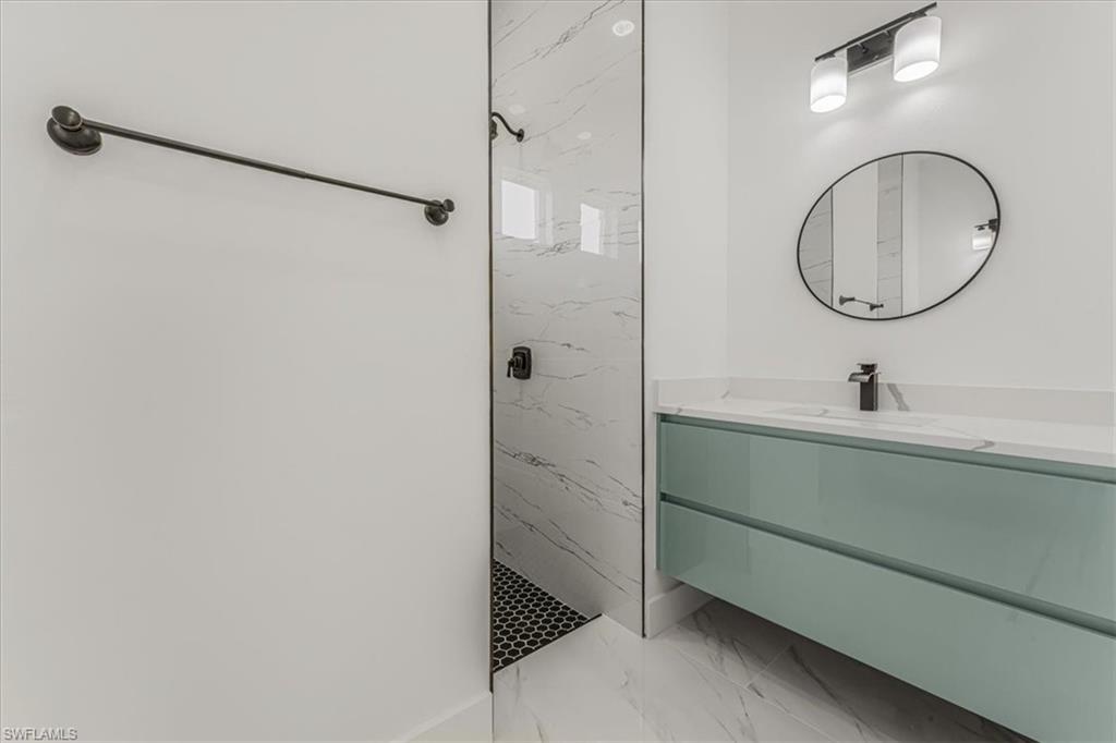 2941 37th Avenue Northeast Naples, FL 34120 - Photo 20 of 46 a bathroom with a sink and a mirror