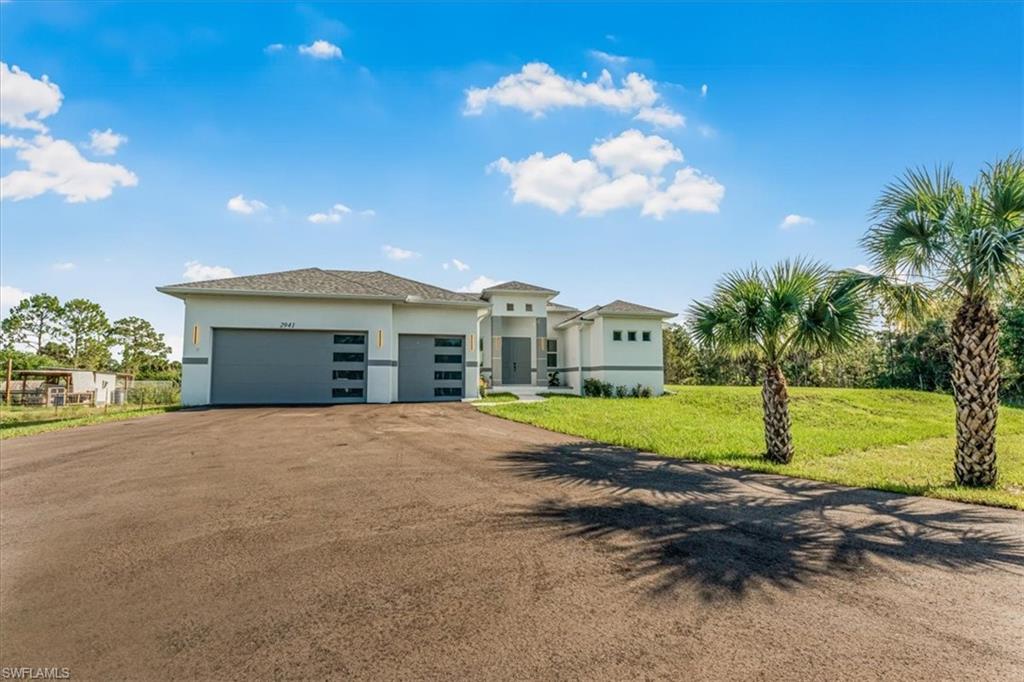 2941 37th Avenue Northeast Naples, FL 34120 - Photo 2 of 46 a front view of a house with garden