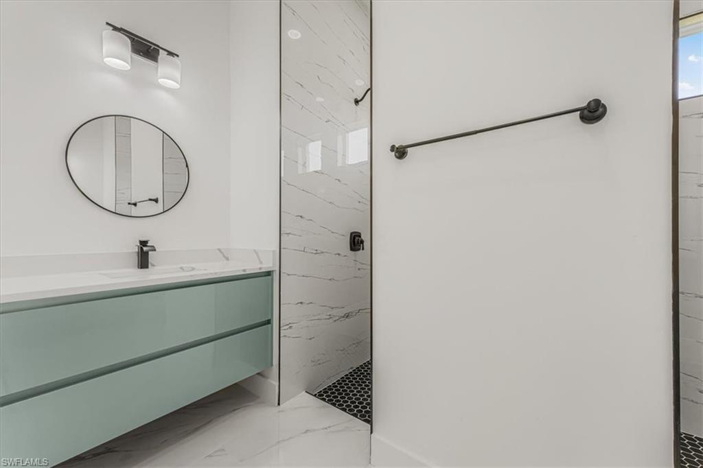 2941 37th Avenue Northeast Naples, FL 34120 - Photo 21 of 46 a bathroom with a sink and a mirror