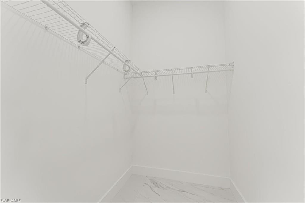 2941 37th Avenue Northeast Naples, FL 34120 - Photo 22 of 46 a view of a room with racks on the wall