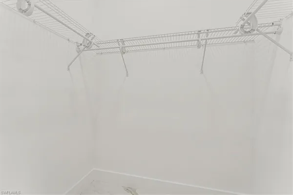 a white toilet sitting next to a white cabinet