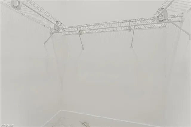 a white toilet sitting next to a white cabinet