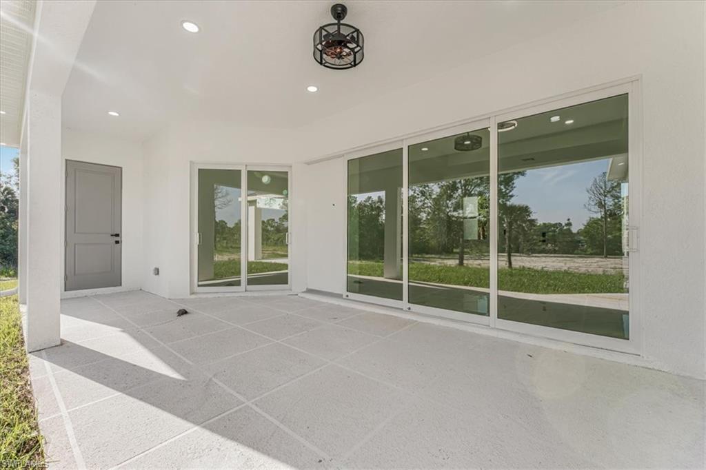 2941 37th Avenue Northeast Naples, FL 34120 - Photo 29 of 46 a view of an empty room with glass door